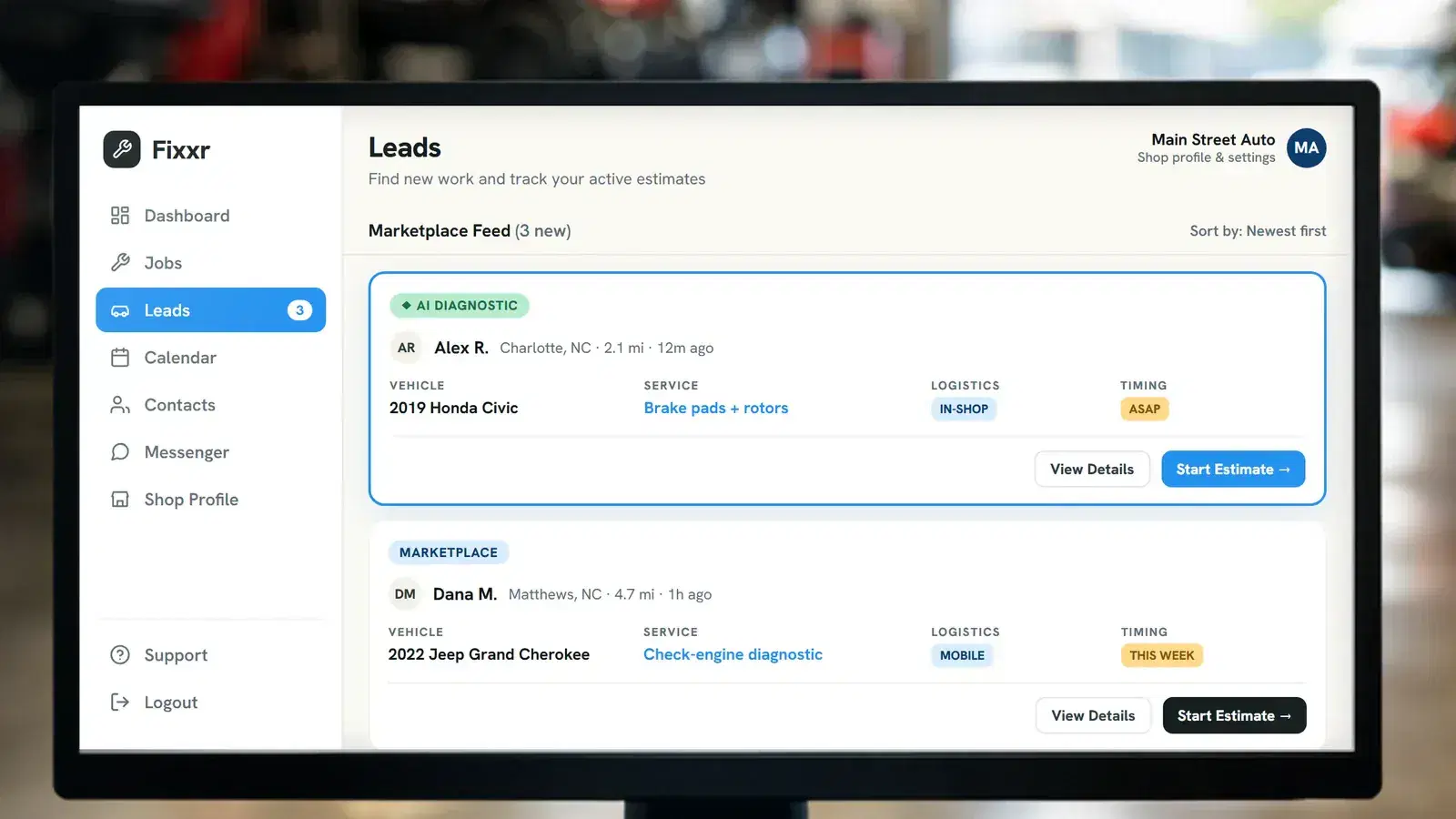 The Fixxr shop dashboard showing incoming local repair leads, on a computer in a working repair shop